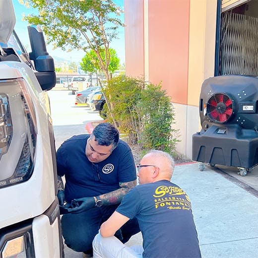 sb evaps portable evaporative cooler with two men fixing a car